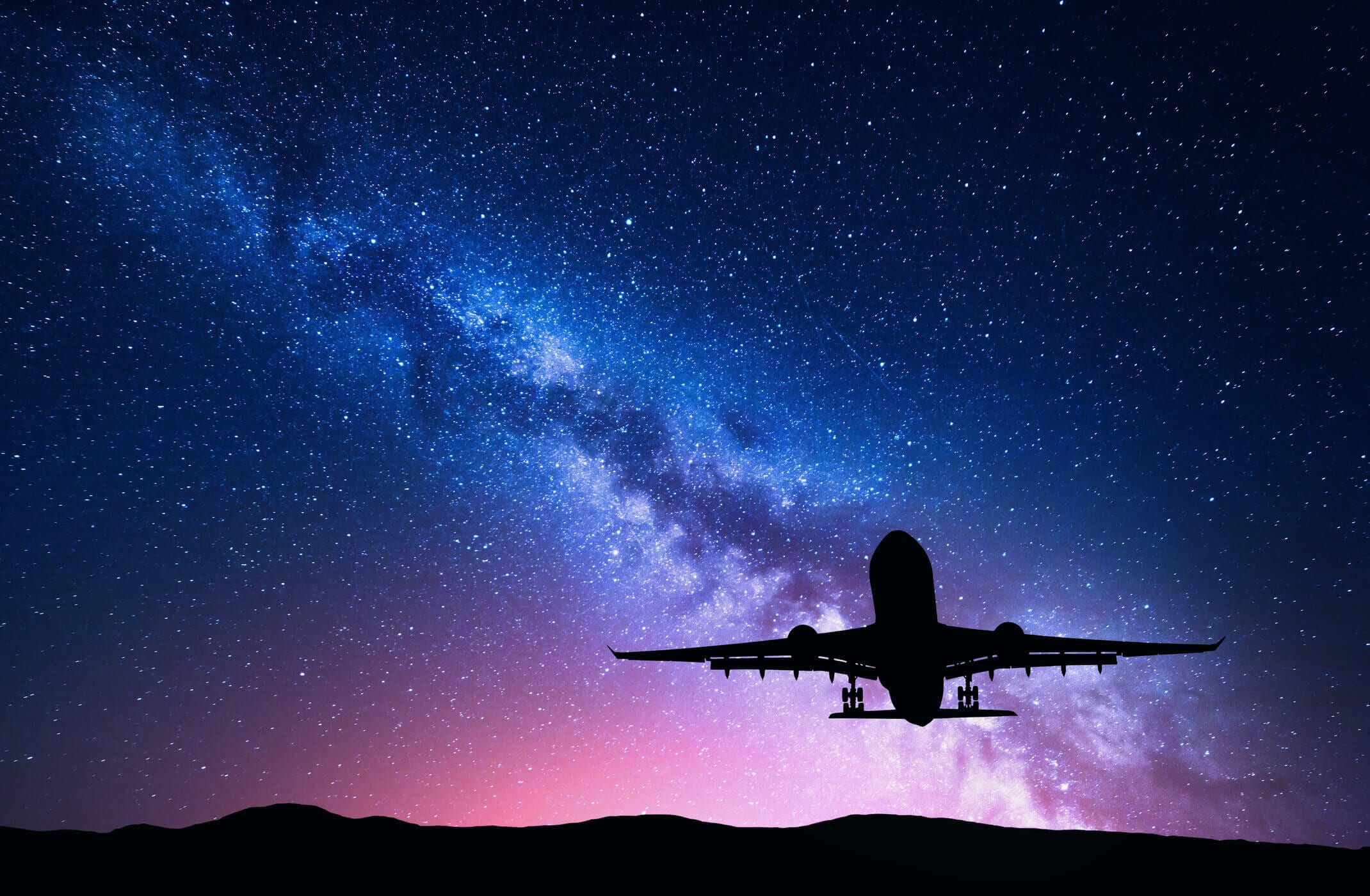 image of plane taking off in night sky